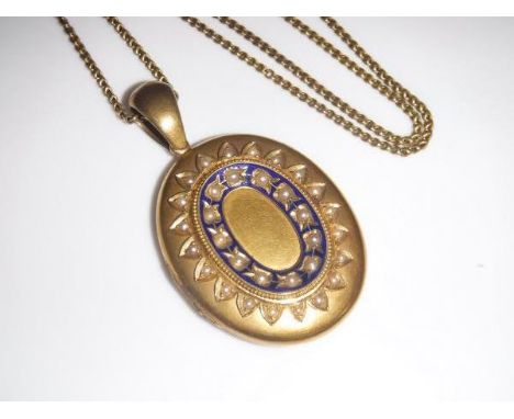 A yellow metal mourning pendant set with seed pearls and enamel decoration, opening to reveal locket of hair and inscribed "T