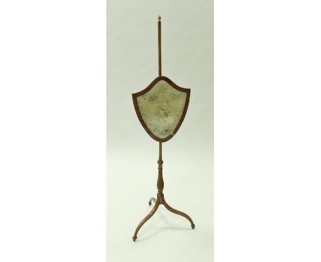 A satinwood shield-shaped pole screen with silk needlework upholstered screen, raised on a writhen baluster turned pole on sp