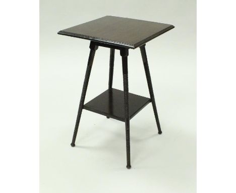 An early 20th Century mahogany two tier occasional table in the manner of Godwin, the square top moulded edge above the four 