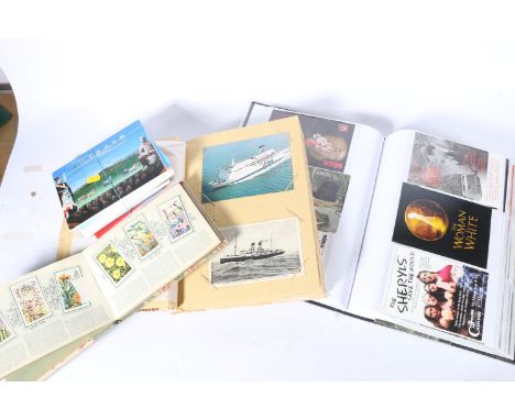 Collection of postcards, photographs and promotional cards contained within three albums and loose, also a collection of thea