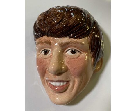 An original hand-painted ceramic wall plaque depicting a profile of George Harrison. Measures approx 12cm tall. C 1960s. 