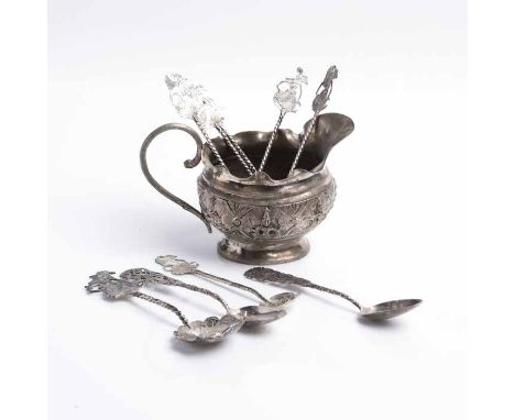 GROUP OF SEVEN BALINESE STYLE SILVER SPOONS 
with shadow puppet shaped finials (one larger spoon and six smaller); along with