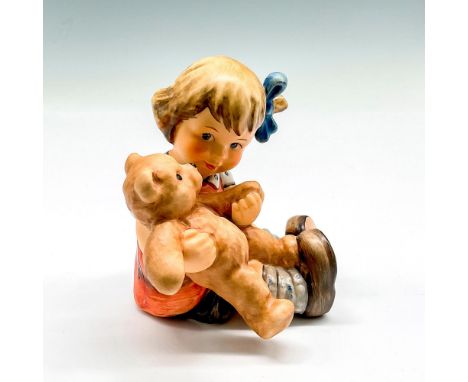Matte finish over hand painted figural holding a bear. Colored in browns, blue and orange. Goebel backstamp. Hummel impressed