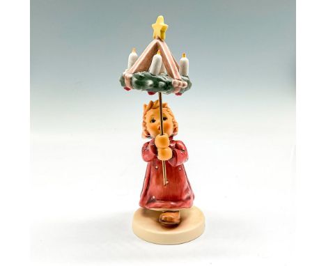 Little figural holding wreath of candles with star. Hand painted in pink, yellow, brown and burgundy. Goebel backstamp. Humme