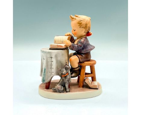 Hand painted figure of a young boy looking over a book with a gray terrier at his feet. Goebel backstamp. Artist: M.I. Hummel