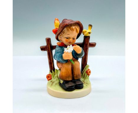 HUM 147; hand painted porcelain figure of a young boy plucking petals from a white flower. Goebel backstamp. Artist: M.I. Hum