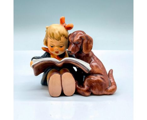 Hand painted figure of a young girl and a Chocolate Labrador reading a book. Goebel backstamp. Artist: M.I. HummelDimensions: