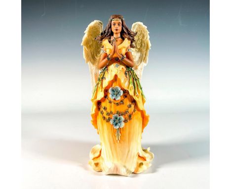 First edition produced in a limited edition, handcrafted cold-cast resin fairy figurine wearing an orange colored dress in th