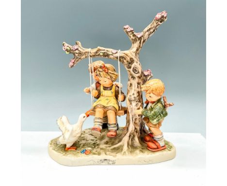 Hummel porcelain figure featuring 3 children playing on a swing with a duck trying to join. Goebel backstamp TMK8. M. I. Humm