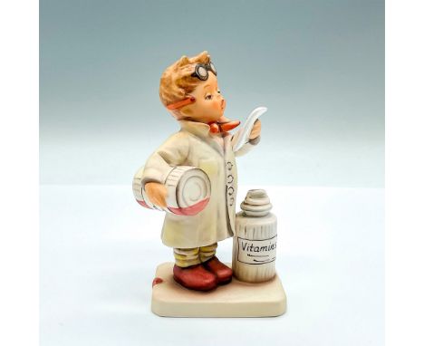 Hand painted figure of a young boy dressed as a pharmacologist. Goebel backstamp. Artist: M.I. HummelIssued: 2004Dimensions: 