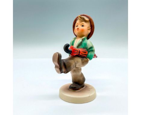 Hand painted figure of a young boy on a walk with an umbrella under his arm. Goebel backstamp. Artist: M.I. HummelIssued: 20t