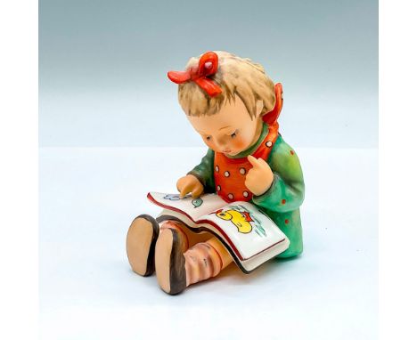 Hand painted figure of a young girl reading a picture book. Goebel backstamp. Artist: M.I. HummelIssued: 20th centuryDimensio