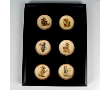 Black shadowbox frame with glass front displays six miniature Goebel Hummel plates. Issued: 20th centuryDimensions: 13"W x 17
