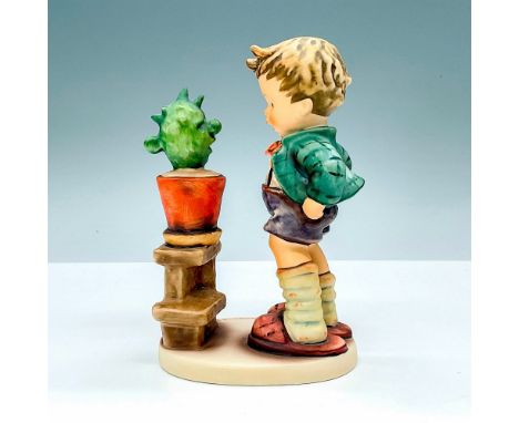 Hummel porcelain figure featuring a boy talking to a cactus. Goebel backstamp TMK6. M. I. Hummel impressed backstamp. Issued: