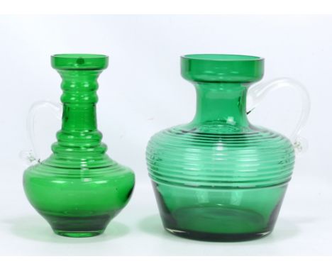 TAMARA ALADIN FOR RIIHIMAEN LASI OY; two 'Kleopatra' pattern green glass jugs with clear handles, the first of unusually larg