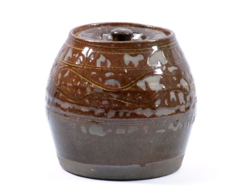 MICHAEL CARDEW (1901-1983) for Winchcombe Pottery; a slipware jar and cover, incised decoration covered in treacle glaze, imp