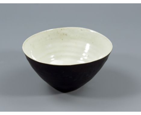 LUCIE RIE (1902-1995); a oval buff stoneware bowl, white pitted glaze to interior, manganese to exterior, impressed LR mark, 
