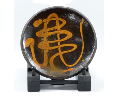 Leach Pottery; an early slipware 'boney pie' dish, impressed HG mark, diameter 18cm.

Additional InformationRim chip and nibb