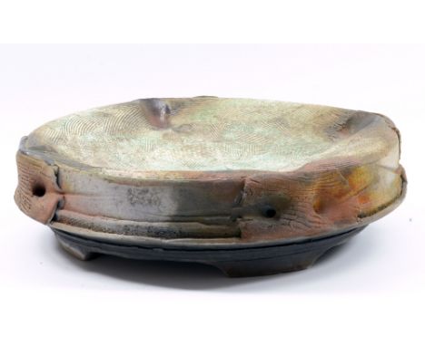 JEFF MINCHAM (born 1950); a large raku platter with incised decoration and copper green glaze to the well, incised signature 