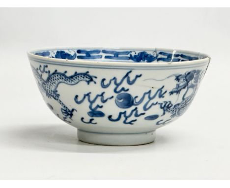 A 19th Century Chinese bowl. Emperor Kangxi mark (1662-1722) With three dragons and flaming pearl. 4 character mark. 15x7cm. 