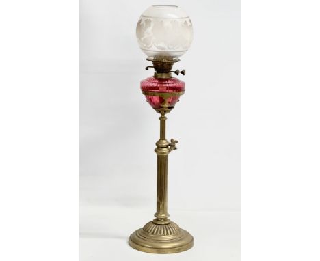 A large Victorian telescopic double burner oil lamp with ruby glass bowl, reeded column and Early 20th Century glass shade. F