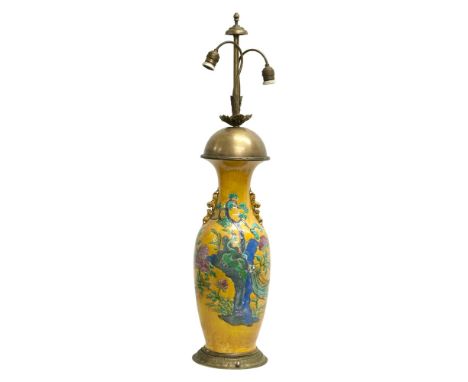 A very large Early/Mid 20th Century Chinese glazed table lamp. Decorated with lotus leaves and peacocks on a yellow glazed gr