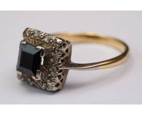 Sapphire and diamond yellow metal and platinum set cluster ring, the square step cut black sapphire measuring approx 5.5 mm x