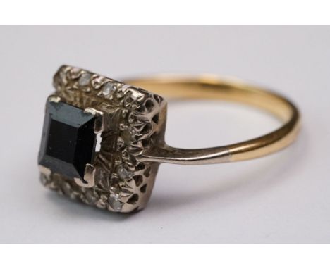 Sapphire and diamond yellow metal and platinum set cluster ring, the square step cut black sapphire measuring approx 5.5 mm x