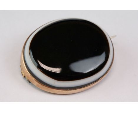 Victorian bulls eye agate unmarked rose gold brooch, the oval cabochon cut bulls-eye agate measuring approx 28mm x 34mm, rub-