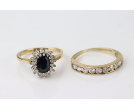 Sapphire and diamond 9ct yellow gold cluster ring, the oval black mixed cut sapphire with small eight cut diamond surround, t