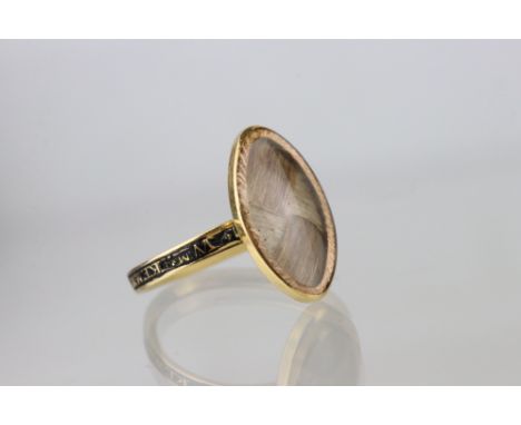 George III hair and enamelled unmarked yellow gold mourning ring, the marquise shaped head containing woven hair, textured su