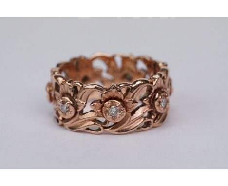 Stuart Devlin for Franklin Mint diamond 14ct rose gold eternity ring, the openwork flower head design set with seven small ro