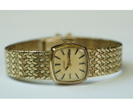 Ladies Eterna 9ct yellow gold wristwatch, gold-coloured square dial, gilt and black baton numerals and pencil hands, stylised