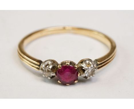 Ruby and diamond 18ct yellow gold three stone ring, the small round mixed cut ruby diameter approx 4mm, two small round brill