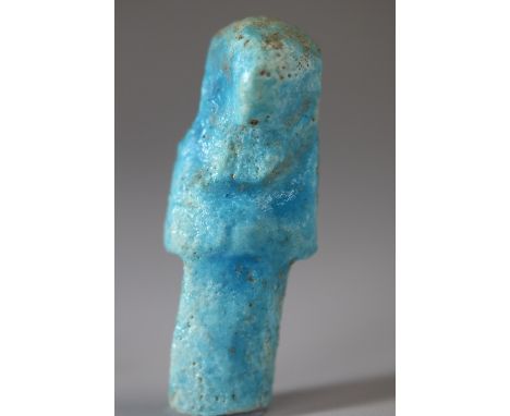 An ancient Egyptian bright blue glazed faience shabti figure fragment.  Background: Shabtis were placed in the tombs amongst 