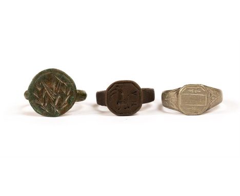 Signet Ring Group,  A group of three bronze rings two engraved to the bezel with geometric motifs, one with a prancing horse 