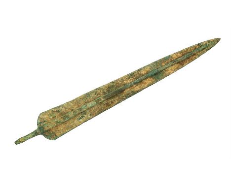 A Luristan Sword, 2nd Millennium BC.  A bronze sword with a long leaf shaped blade; central rib to the body, long tang to the