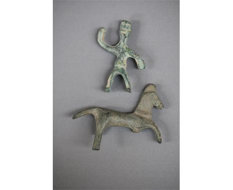 Romano-British Horse and Rider God, 1st century AD.   A bronze figurine of a stylised male with right arm raised, seated to a