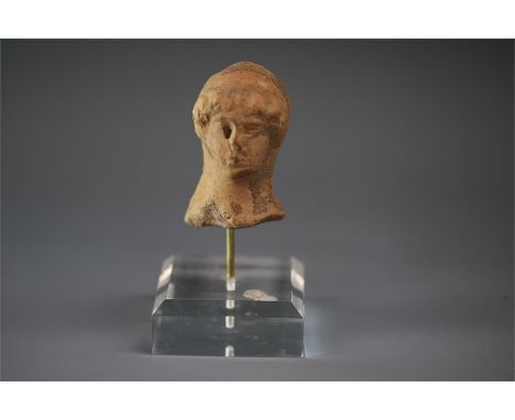 Greek terracotta head of a goddess,  5th century BC.   A ceramic head of a female, possibly a goddess, with hair in a series 