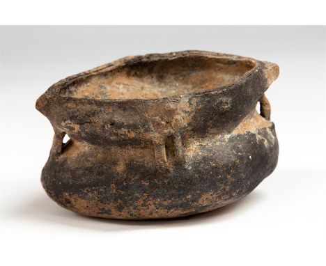 A ceramic vessel with flat rim and square shaped mouth; the sides to the neck decorated withapplied discs and handles in the 