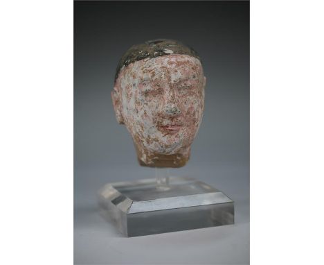 Chinese Tang Dynasty Head of a Courtier, 618-907 AD  A ceramic head of a youthful male courtier, possibly a eunuch, with hair