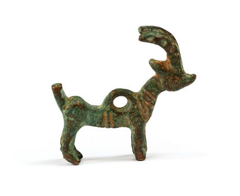 Western Asiatic Luristan ibex amulet, 2nd- 1stmillennium BC.   A bronze amuletic pendant in the form of a standing ibex or go
