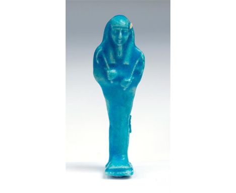 Egyptian Ptolemaic Period Faience Shabti, C. 4th Century BC.  A bright blue faience mummiform ushabtis, wearing a tripartite 