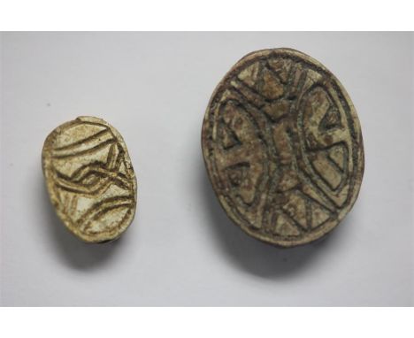 Egyptian Scarab and Cowrie Shell Amulet Group; New Kingdom, 1550-1077 BC.&nbsp; &nbsp;A pair of faience amulets consisting of