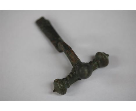 Roman Crossbow Brooch, 2nd century ADA bronze crossbow brooch with flat plate, arching central body and cross bar with termin