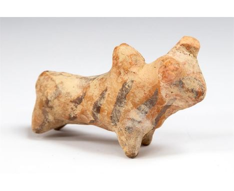 A ceramic figure of a bull with large horns pointing forward, dewlap to neck, hump to the back.   The body painted with black