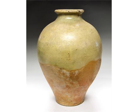 Han Dynasty Glazed Jar, 202-220 AD  A ceramic glazed jar with pale celadon glaze; rolled rim with short neck; bulbous body ta