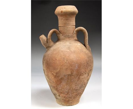 Roman Twin Handled Jug, C. 3rd - 4th Century AD.   A twin handled jug made of ceramic with a long neck. Intact.Size: 32cm.Pro