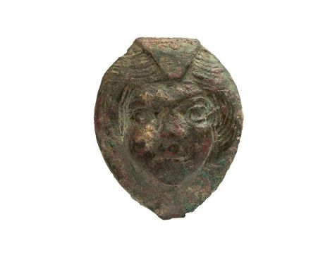 Cupid Face Fitting, 1st-3rd century AD.   A bronze fitting in the form of the face of Cupid with hair arranged across the top