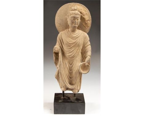 Gandhara Buddha as Begging Mendicant Statue, 2nd-3rd century AD  A schist statue of the Buddha, hair pulled up into the ushni